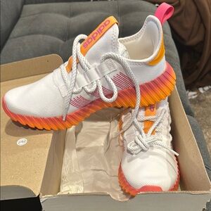 Adidas White and Orange Sneakers with Mesh Upper and Textured Sole.